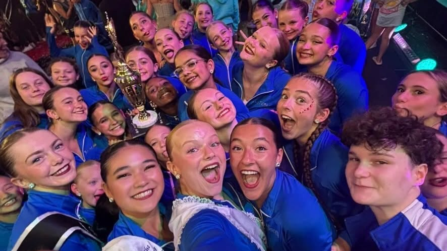 Trophy in hand and all smiles — the crew celebrates a national win.